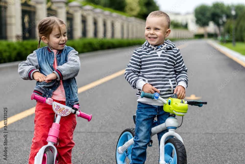 Happy kids with bikes having fun on the road at the day time. Happy kids with bikes having fun on the road at the day time.