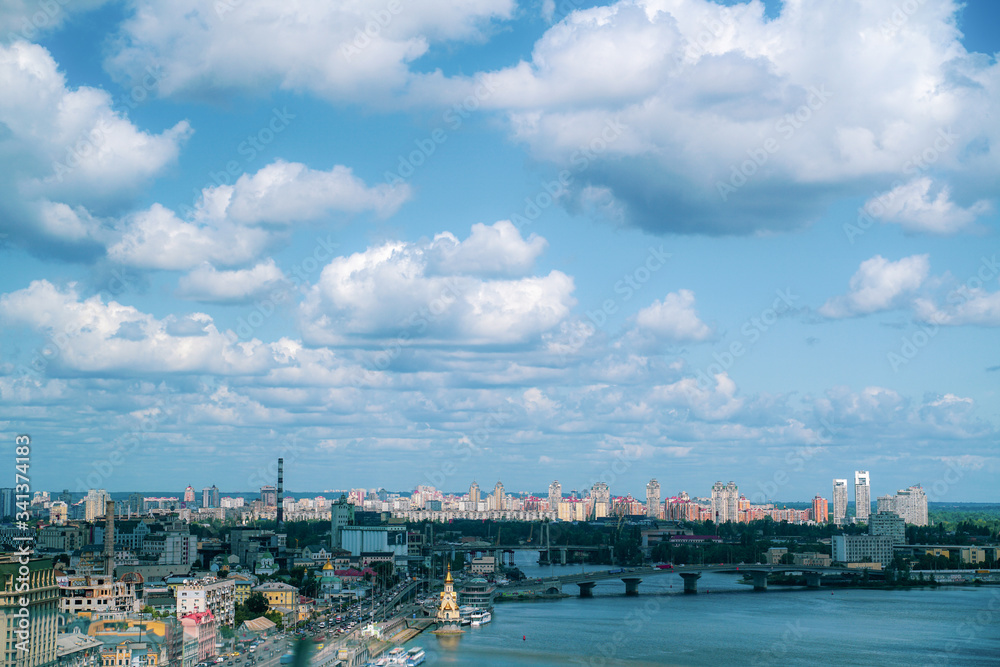 Sky with fluffy clouds over city in summer, Kiev, Ukraine. Cityscape.