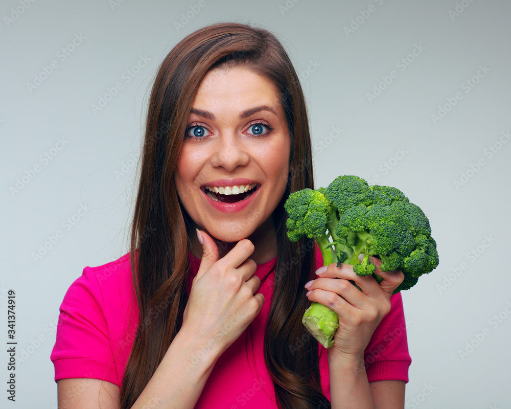 Healthy food dieting with smiling woman holding green broccoli. Healthy food dieting with smiling woman holding green broccoli.