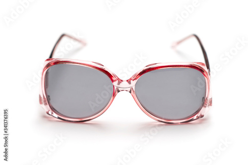 A front view of a pair of stylish female sunglasses isolated on white.