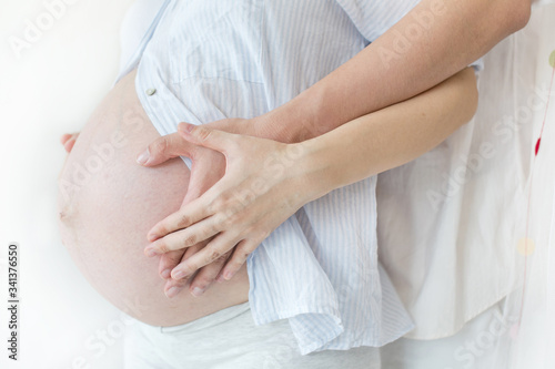 Wallpaper Mural Pregnant Belly with Hands of mother and father. Torontodigital.ca