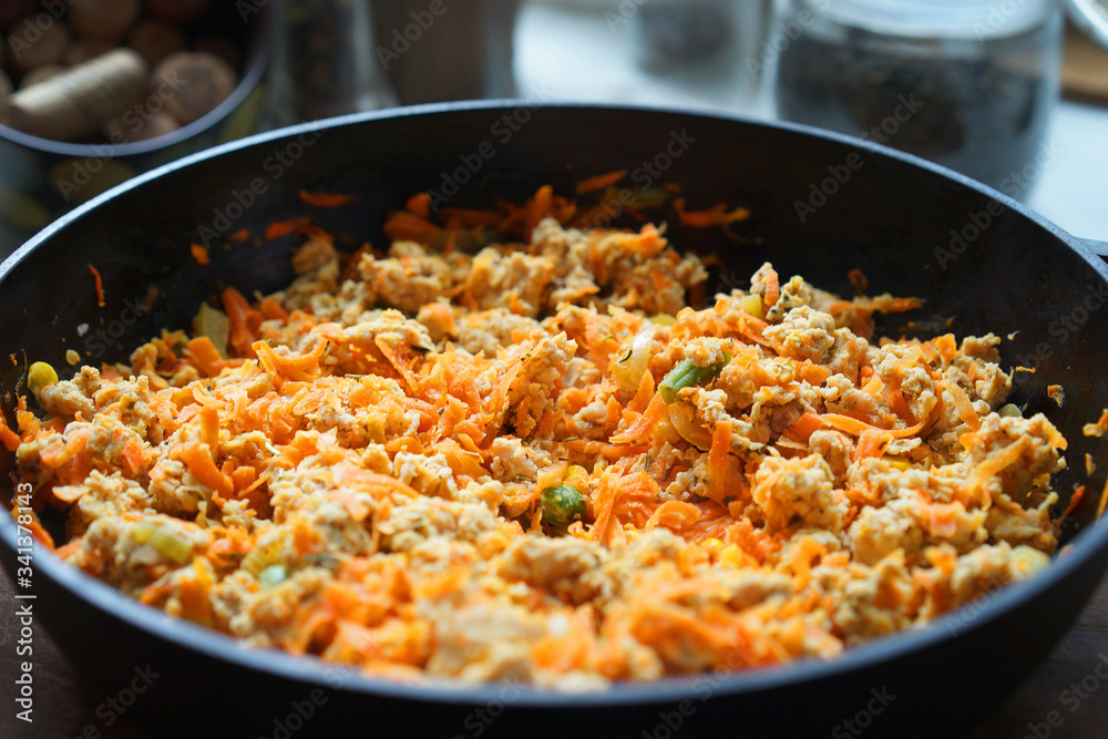 Cooking at home kitchen chicken meat side dish. Cook fry minced meat with vegetables. Cooking at home kitchen chicken meat side dish. Cook fry minced meat with vegetables.
