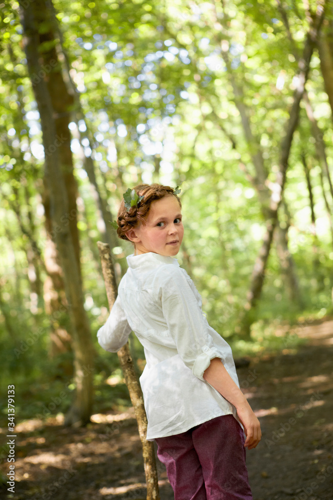 Portrait of girl with wood stick walking in forest Portrait of girl with wood stick walking in forest