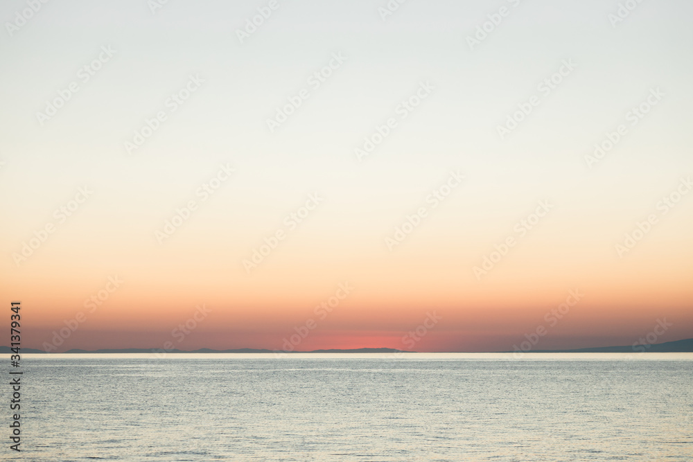 Magical sunset on the calm sea horizon