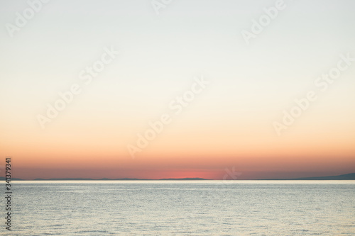 Magical sunset on the calm sea horizon