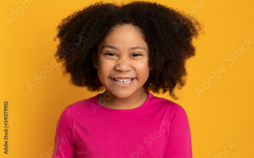 Portrait Of Funny Cute African American Little Girl Laughing At Camera