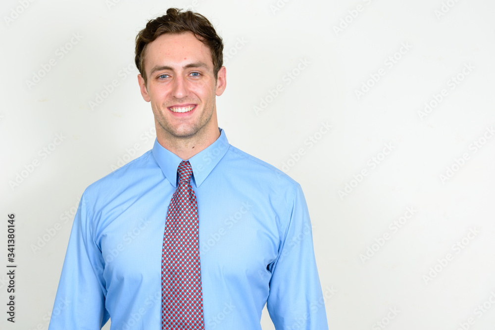 Portrait of happy young handsome businessman smiling Portrait of happy young handsome businessman smiling