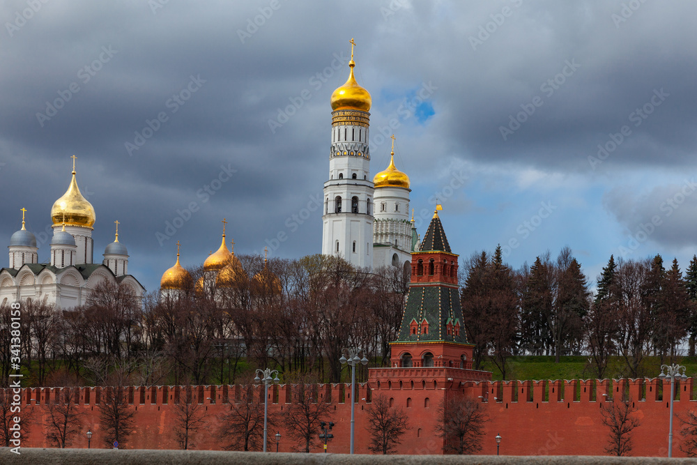 View of the Moscow Kremlin with a fortress wall and golden-domed churches