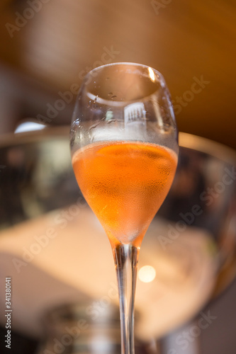 A glass of sparkling pink champagne