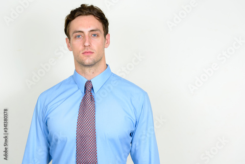 Portrait of young handsome businessman looking at camera
