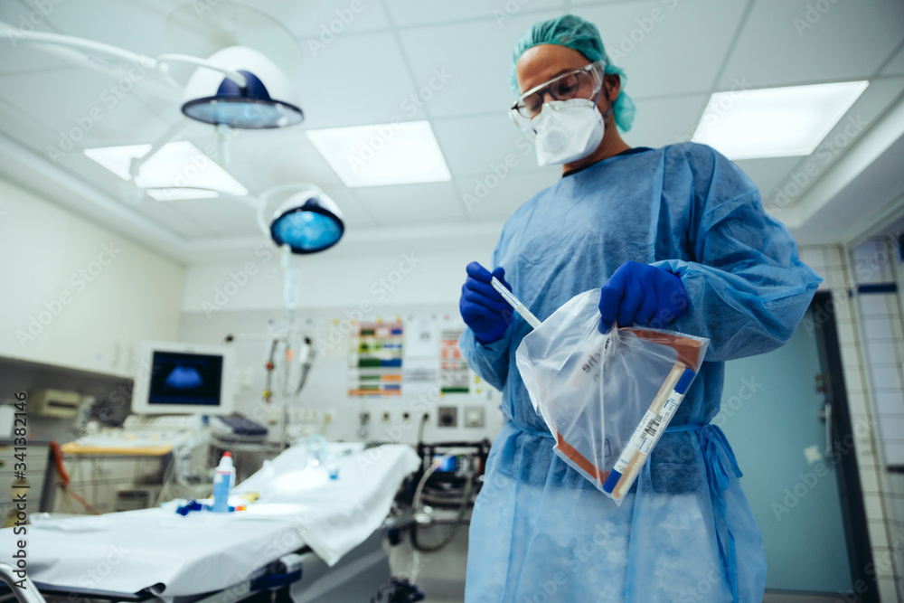 Emergeny doctor putting a swab into a plastic bag in hospital Emergeny doctor putting a swab into a plastic bag in hospital