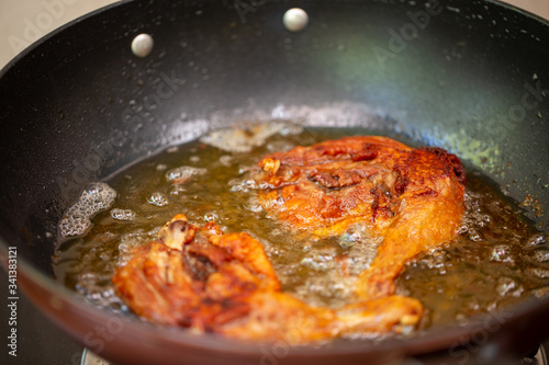 Fry the chicken in a pan with boiling oil.