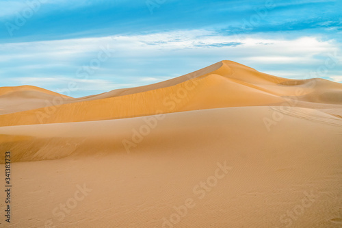 Peaceful landscape of Sahara Desert sand dunes, Morocco.