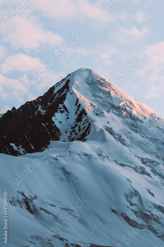 Pamir Lenin Peak Kyrgyzstan Lonely snowy mountain peak against a blue sky Sunset
