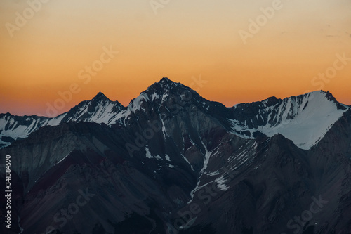 Pamir. Peak of Lenin. mountain landscape on a background of orange sky