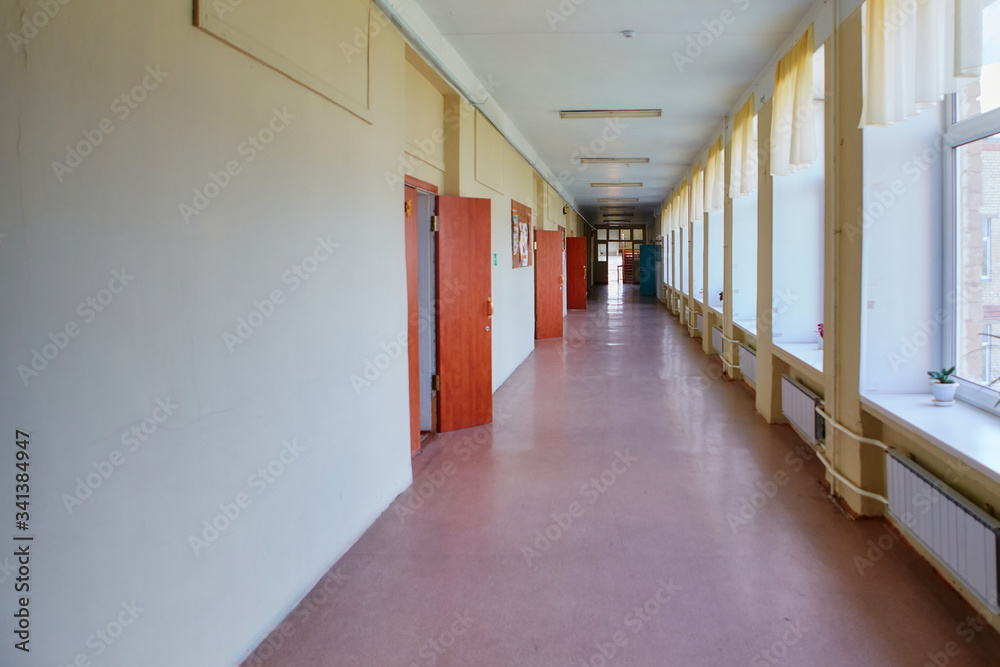 An empty school corridor stretching into the future. The concept of holidays, quarantine, evacuation