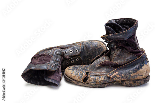 Old and torn boots were put on the floor {clipping path}