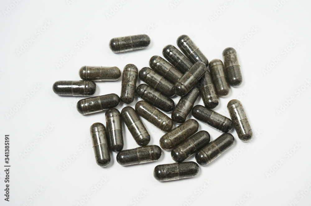 Close up view of Habbatussauda jinten hitam powder extract nigella sativa black seed in capsules, isolated on white background. Close up view of Habbatussauda jinten hitam powder extract nigella sativa black seed in capsules, isolated on white background.