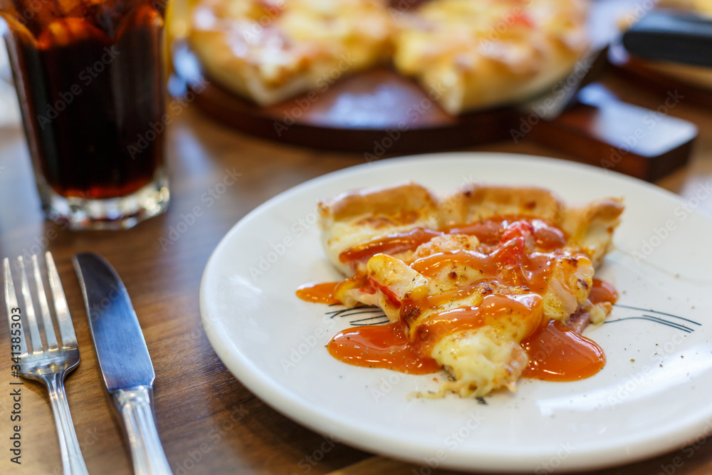 Seafood Italian Pizza slice on wood dish Seafood Italian Pizza slice on wood dish