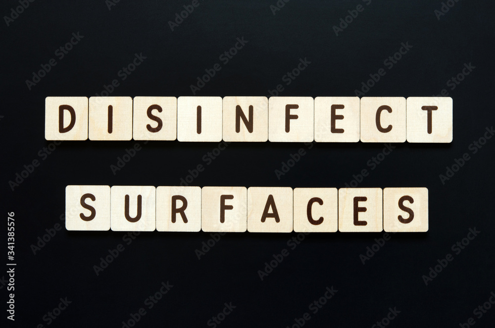 DISINFECT SURFACES - words from wooden blocks with letters. Top view on black background. - Image DISINFECT SURFACES - words from wooden blocks with letters. Top view on black background. - Image