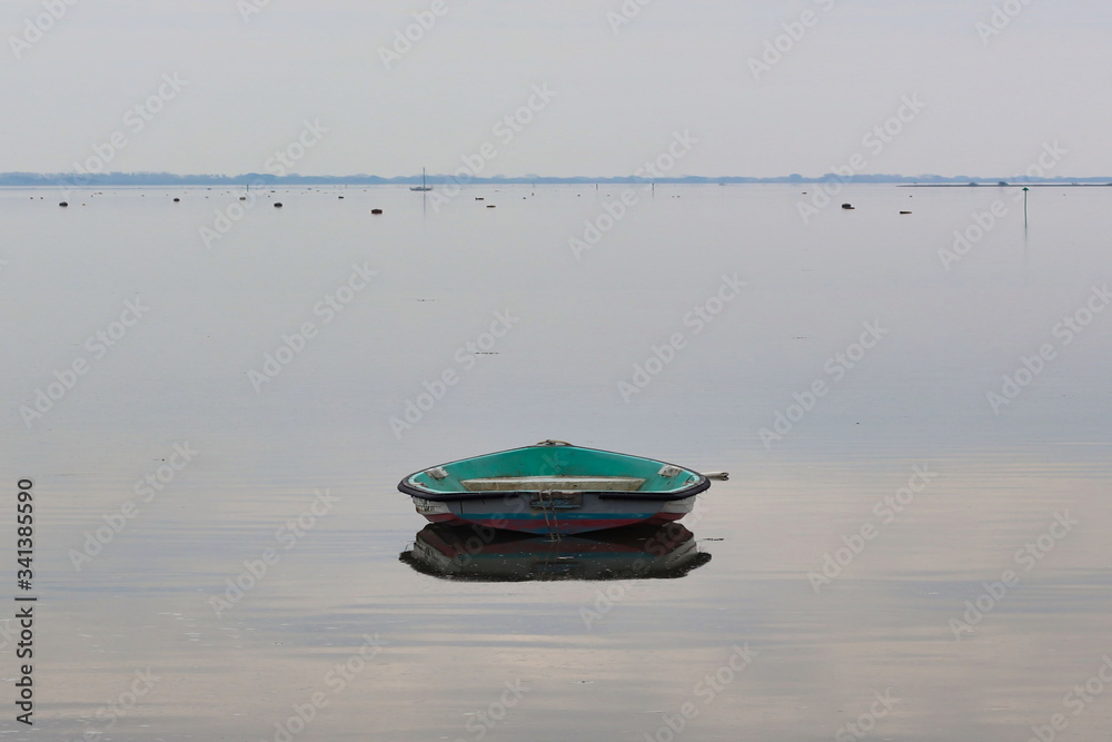 Green boat reflecting on the water Green boat reflecting on the water