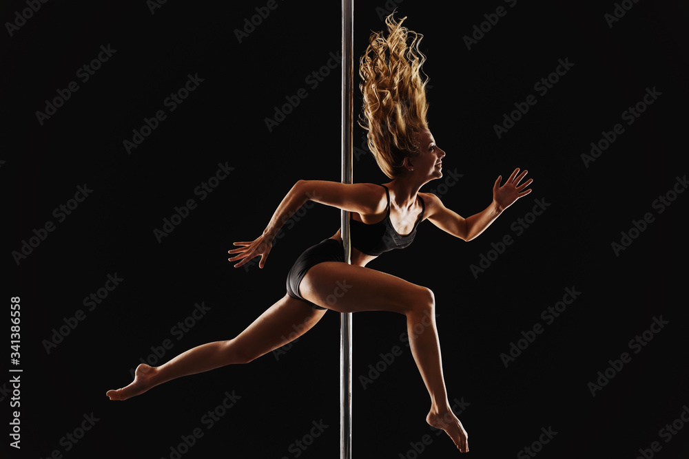 Beautiful young blonde woman jumping happy and excited hanging upside down - vetically mirrored image