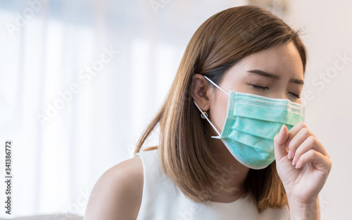 Asian women wearing masks are sick, She has a cough and a sore throat.