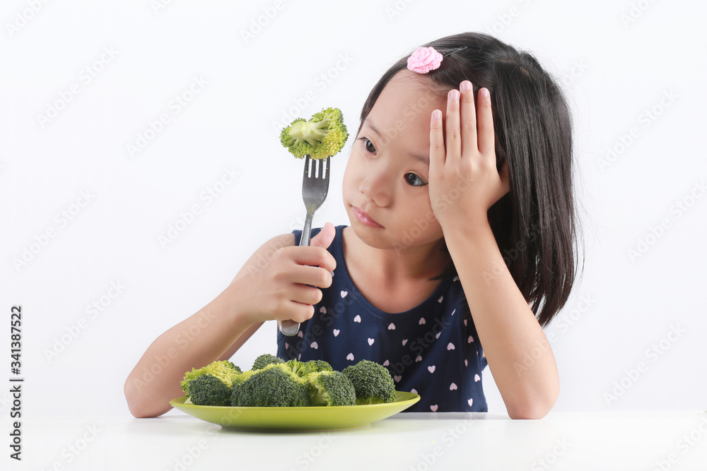 Little Asian girl refuses to eat healthy vegetables. Little Asian girl refuses to eat healthy vegetables.