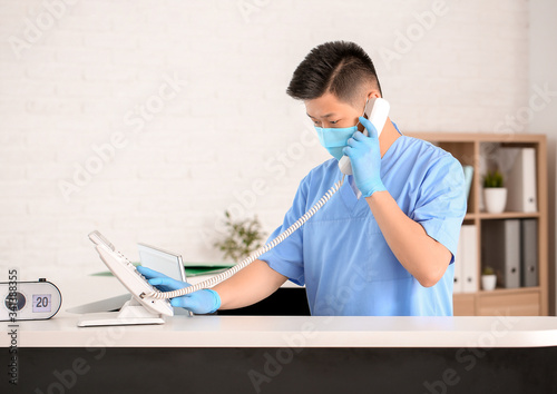 Asian male receptionist wor...