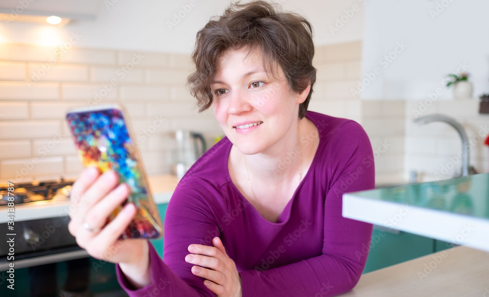 Online call friends concept. Young woman talking through a video call on a smartphone Online call friends concept. Young woman talking through a video call on a smartphone