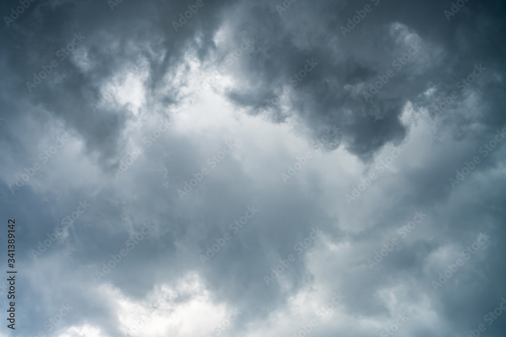 Background of beautiful dark clouds before a raining and thunder-storm. A dramatic sky with gray dense clouds. view from ground surface.sad feel.