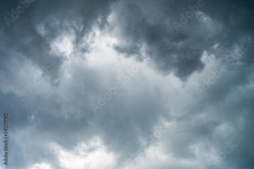 Background of beautiful dark clouds before a raining and thunder-storm. A dramatic sky with gray dense clouds. view from ground surface.sad feel.