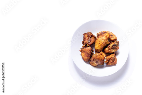 Fried Chicken on a plate with isolated white shot