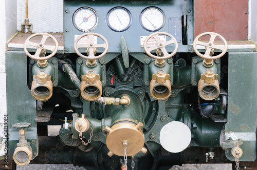 Water hose valves on the back of a "Green Goddess" military fire engine.