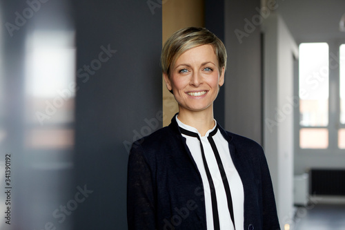 Portrait of smiling businesswoman in office photo