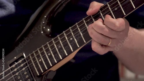 man playing guitar solo with black guitar