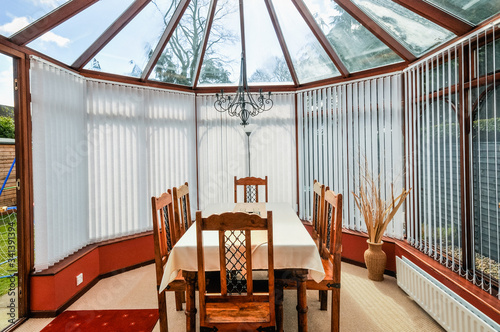 Dining table in a household conservatory photo