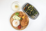 Ayam penyet East Javanese cuisine smashed fried chicken dish with floss sambal slices of cucumbers fried tofu and tempeh Stair fired green Chinese broccoli garlic oyster sauce soup