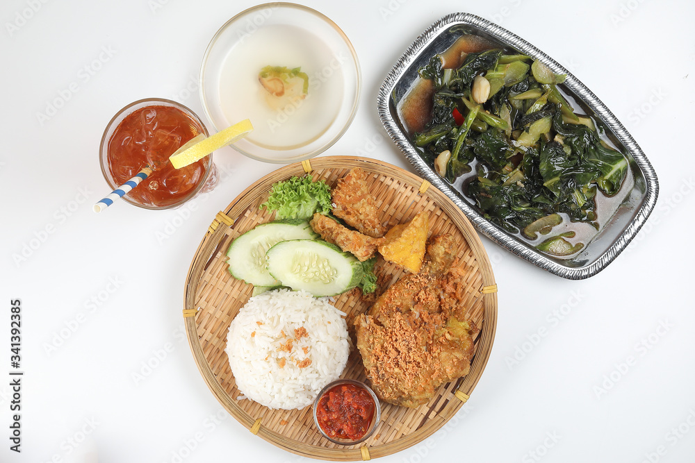 Ayam penyet East Javanese cuisine smashed fried chicken dish with floss sambal slices of cucumbers fried tofu and tempeh Stair fired green Chinese broccoli garlic oyster sauce ice lemon tea soup Ayam penyet East Javanese cuisine smashed fried chicken dish with floss sambal slices of cucumbers fried tofu and tempeh Stair fired green Chinese broccoli garlic oyster sauce ice lemon tea soup
