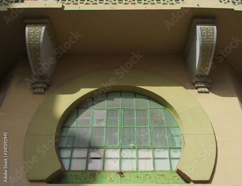 Revival architecture in the city of Melilla. Spain.
Neo-arabic glazed Building. 1927. Detail of brackets and window with horseshoe arch.  photo