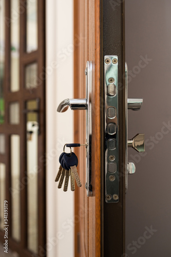 Strong lock with keys in the front door. door lock with keychain, open door