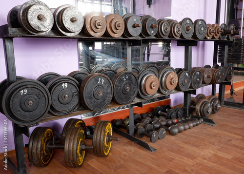 Old gym interior with old school dumbbells and equipment