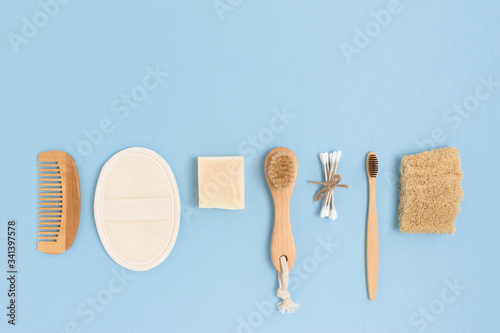 Layout of zero waste accessories for personal hygiene on a blue background. Plastic free concept with copy space.