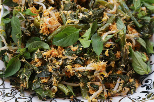 Urap (Indonesia Traditional Food). Urap is a salad dish of steamed vegetables mixed with seasoned and spiced grated coconut for dressing. photo