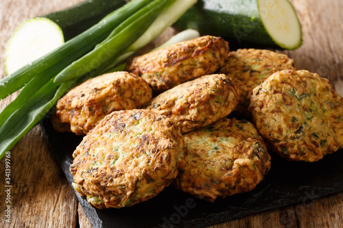 Greek zucchini and feta fritters Summer Light Snack close-up on a slate board. Horizontal photo