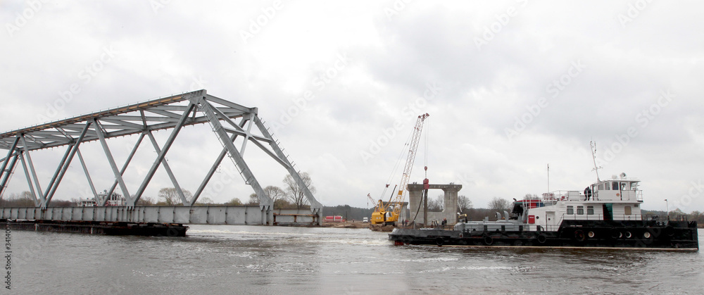 River Tug carries part of the bridge on a barge