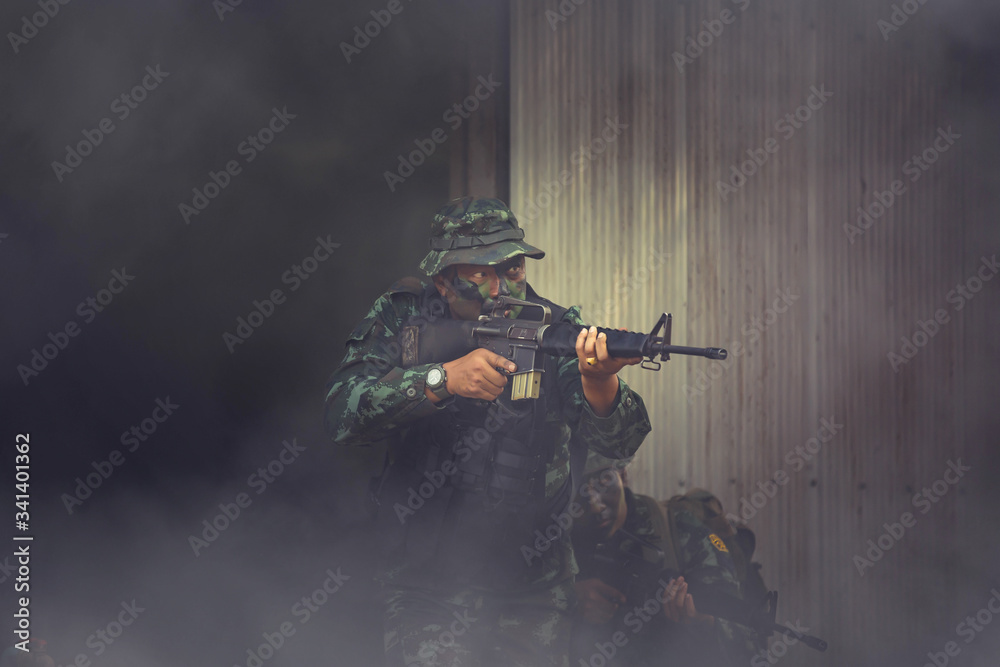 Fototapeta premium Special forces. soldier assault rifle with silencer. sniper in the forest. 