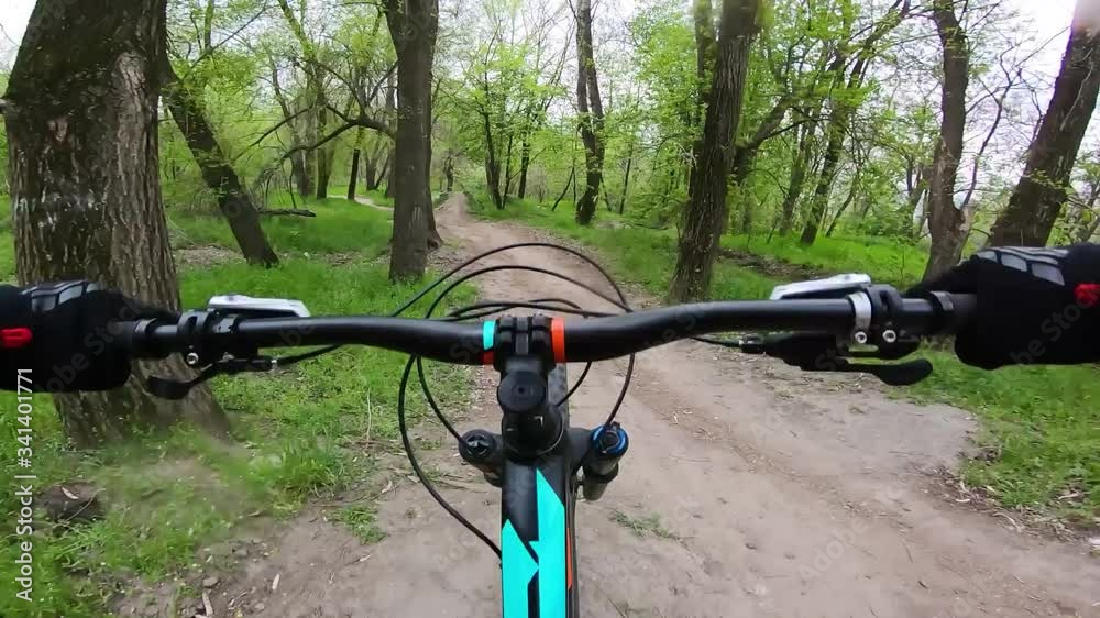 First-person view of a cyclist riding a mountain bike. Downhill. Speed bike race.