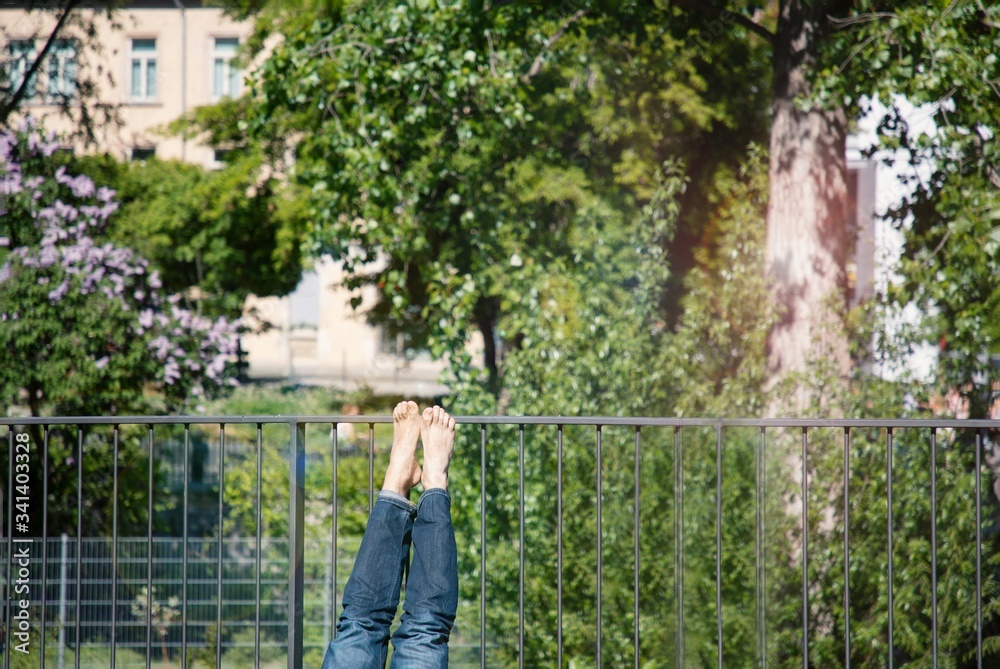 Legs barefoot sunbathing in the balcony. Fragment, details Legs barefoot sunbathing in the balcony. Fragment, details