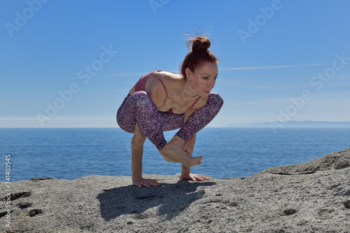 Portrait of a fit woman who practices yoga outdoors. Woman practicing asanas on a sunny day